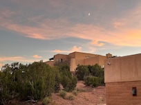 View of moon over ownersâ house up the hill