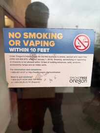 Homeless camping outside this sign smoking.