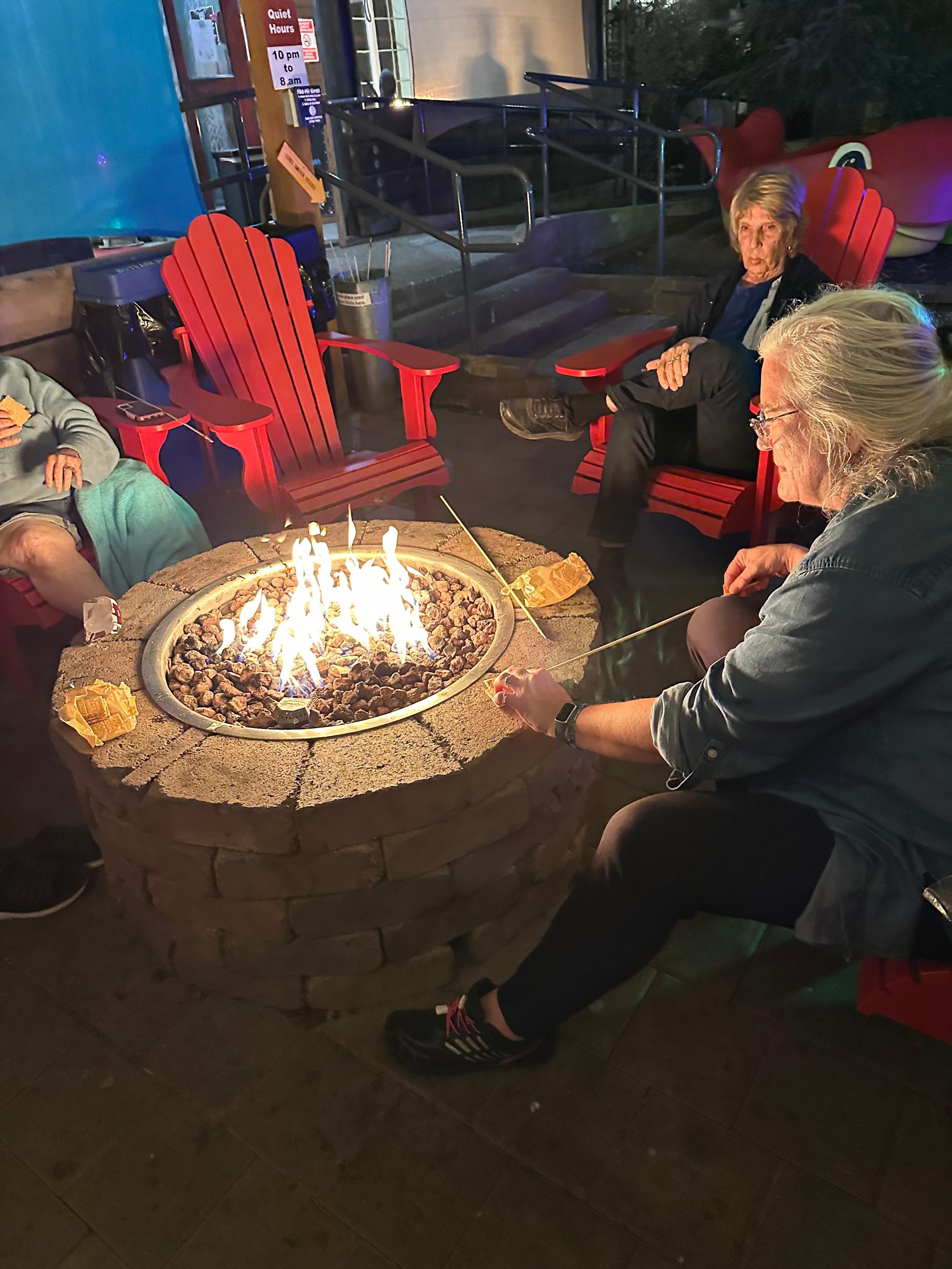 Comfy chairs around the timed fire pit.