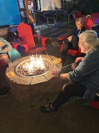 Comfy chairs around the timed fire pit.