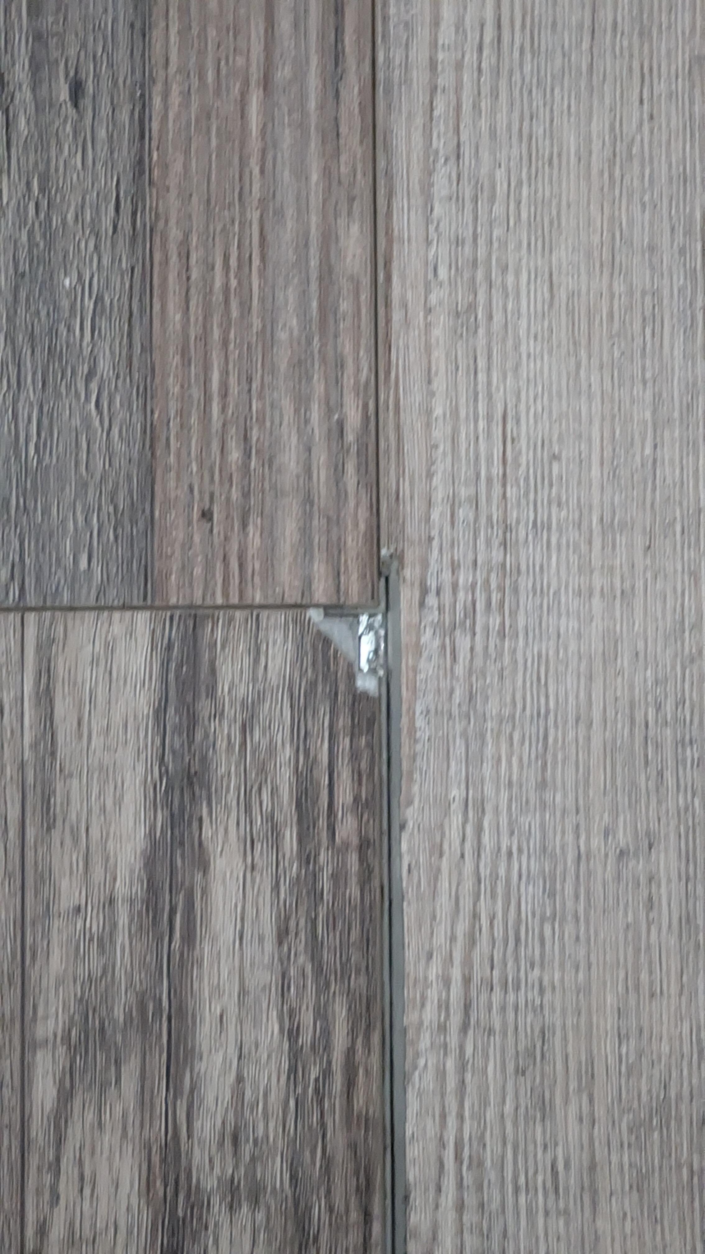 Example of chipped flooring in kitchen (catches on socks)