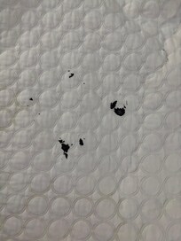 Black, tar like stain on bedspread. It was hard to the touch. There was also dried leaves in my bed that did not come from me. I don’t think sheets were changed.