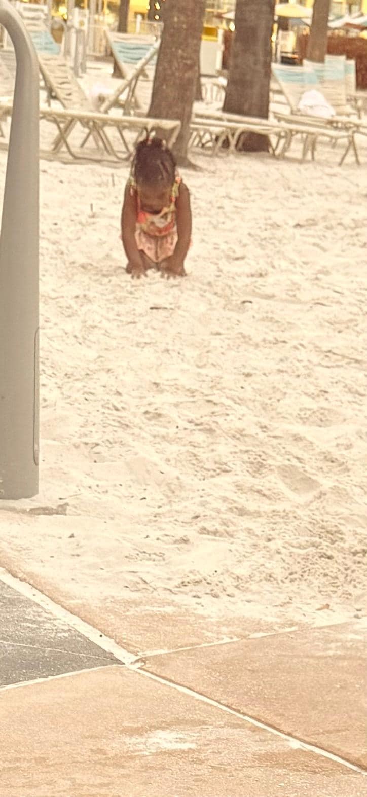 My granddaughter playing in the sand 