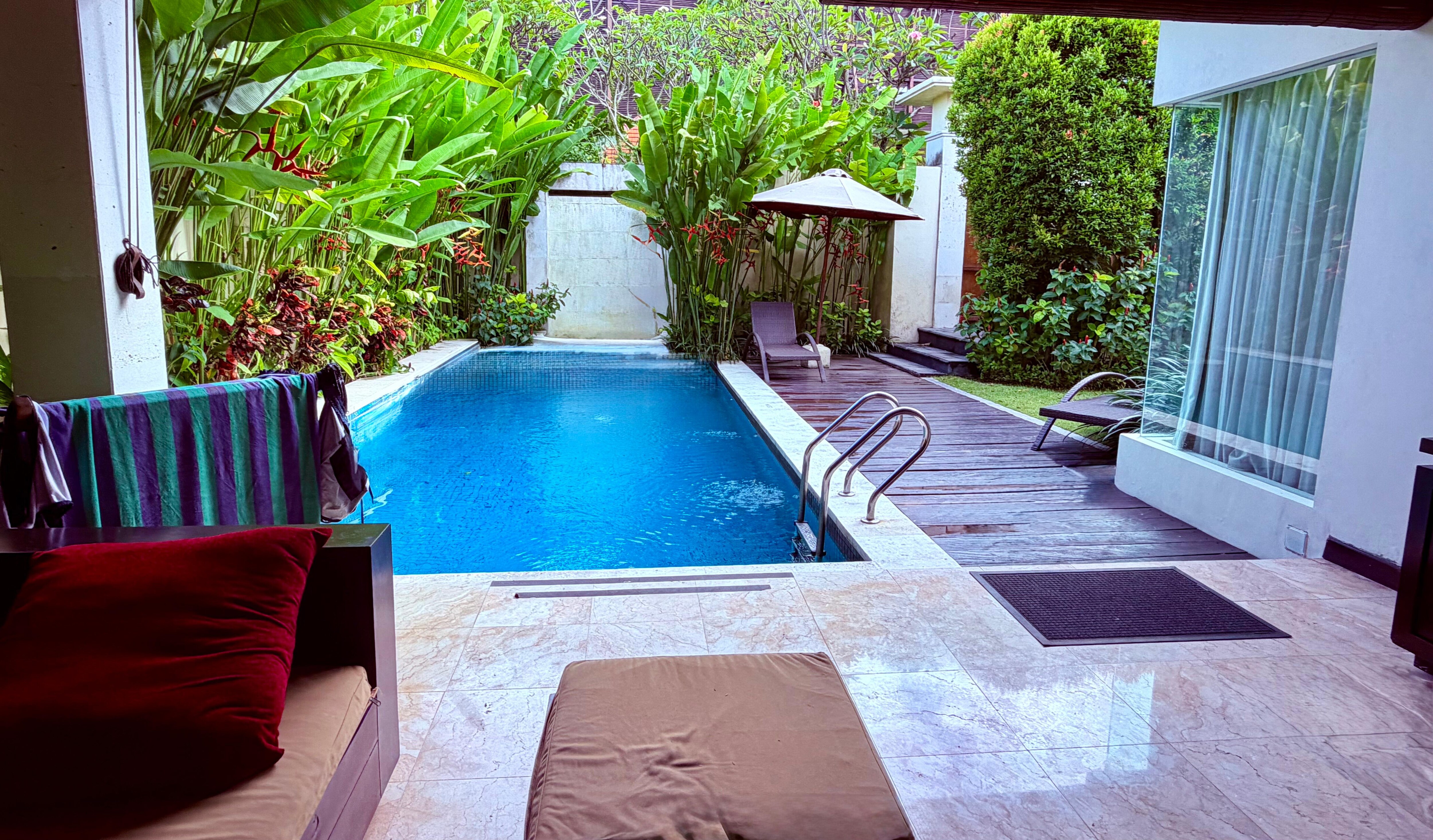 Chilling in the lounge area overlooking our refreshing private pool.  🏊‍♂️ To the right is the sleeping/bathroom pavilion.  