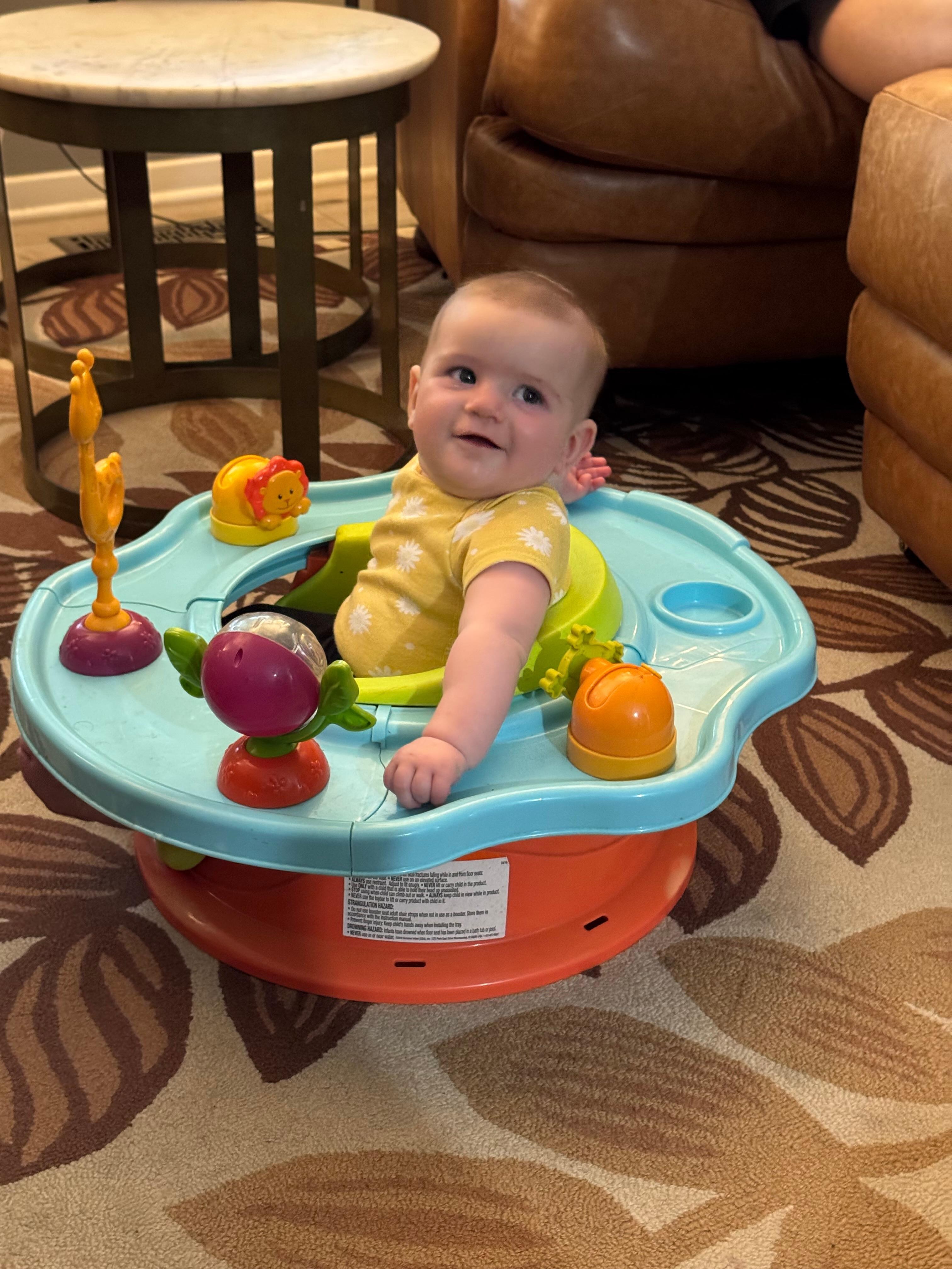 Granddaughter enjoying activity seat provided by host. 