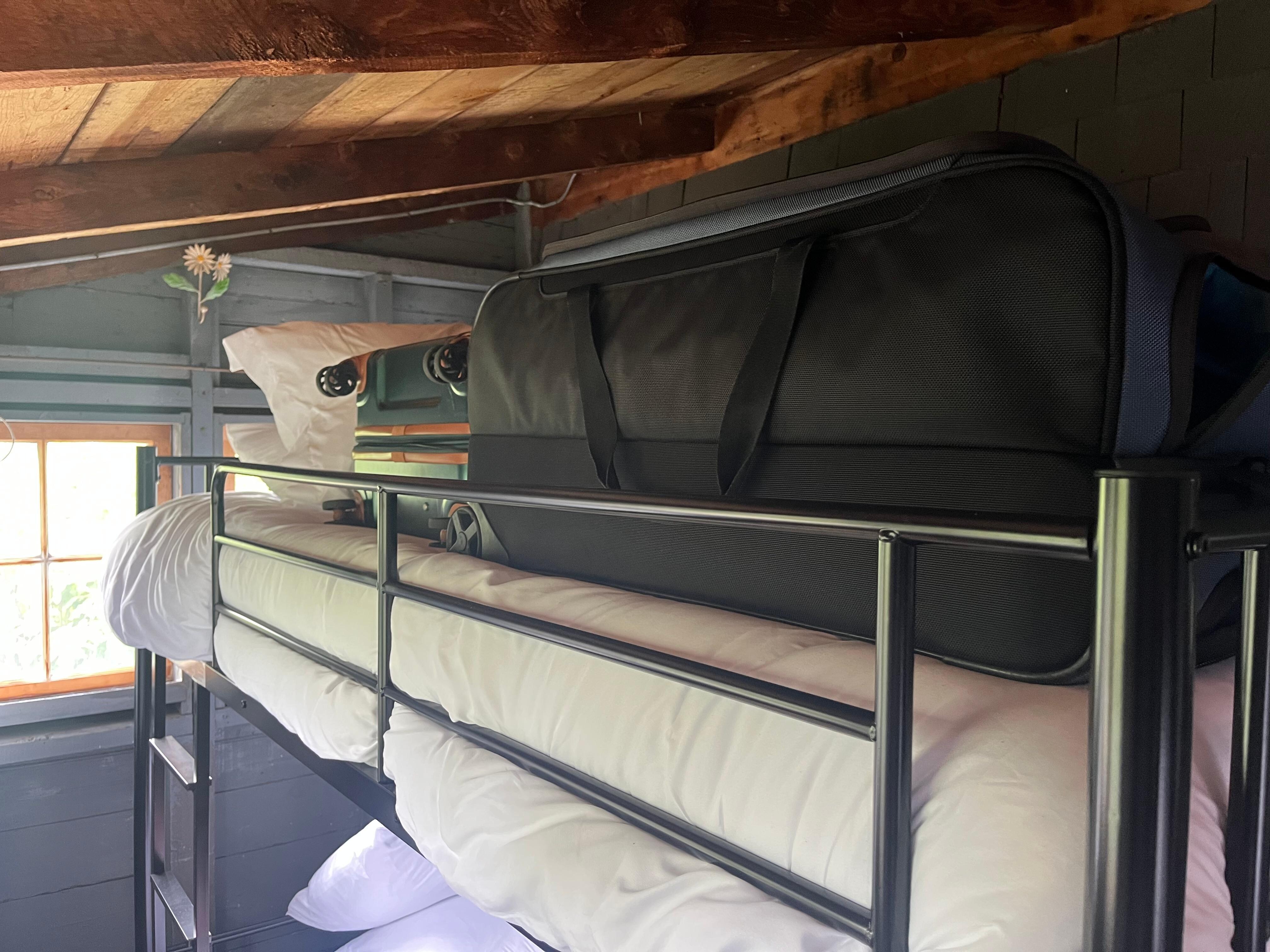 The bunk bed is dangerously close to the ceiling.