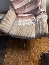 Dirty chair in living room where there was one tv