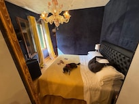 Gorgeous bedroom with side nook for clothing. The breeze through the room is fantastic.