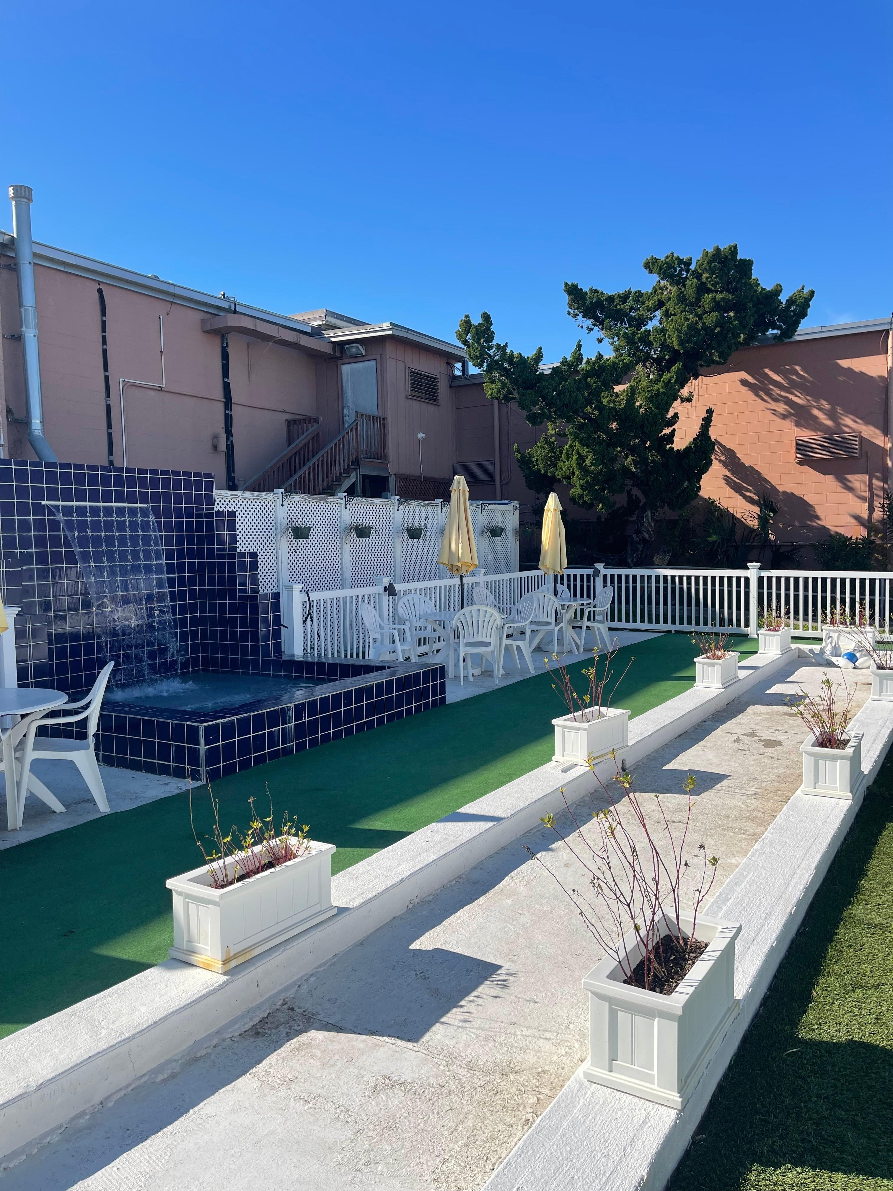 Outdoor seating, bowling, and a water feature