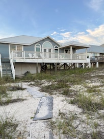 There were wooden planks from the house to the small decline to the beach. The first wooden plank at the porch was broken up, so be careful to not get a splinter.