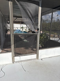 Door in pool area scree hanging.