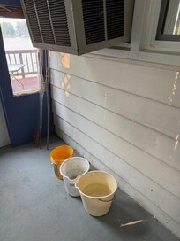 Buckets collecting water from A/C Window Unit