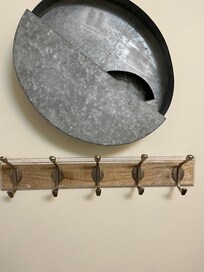 Tin decoration barely hanging on one screw!