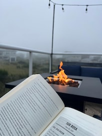 Reading by the fire upstairs while the fog rolls in.