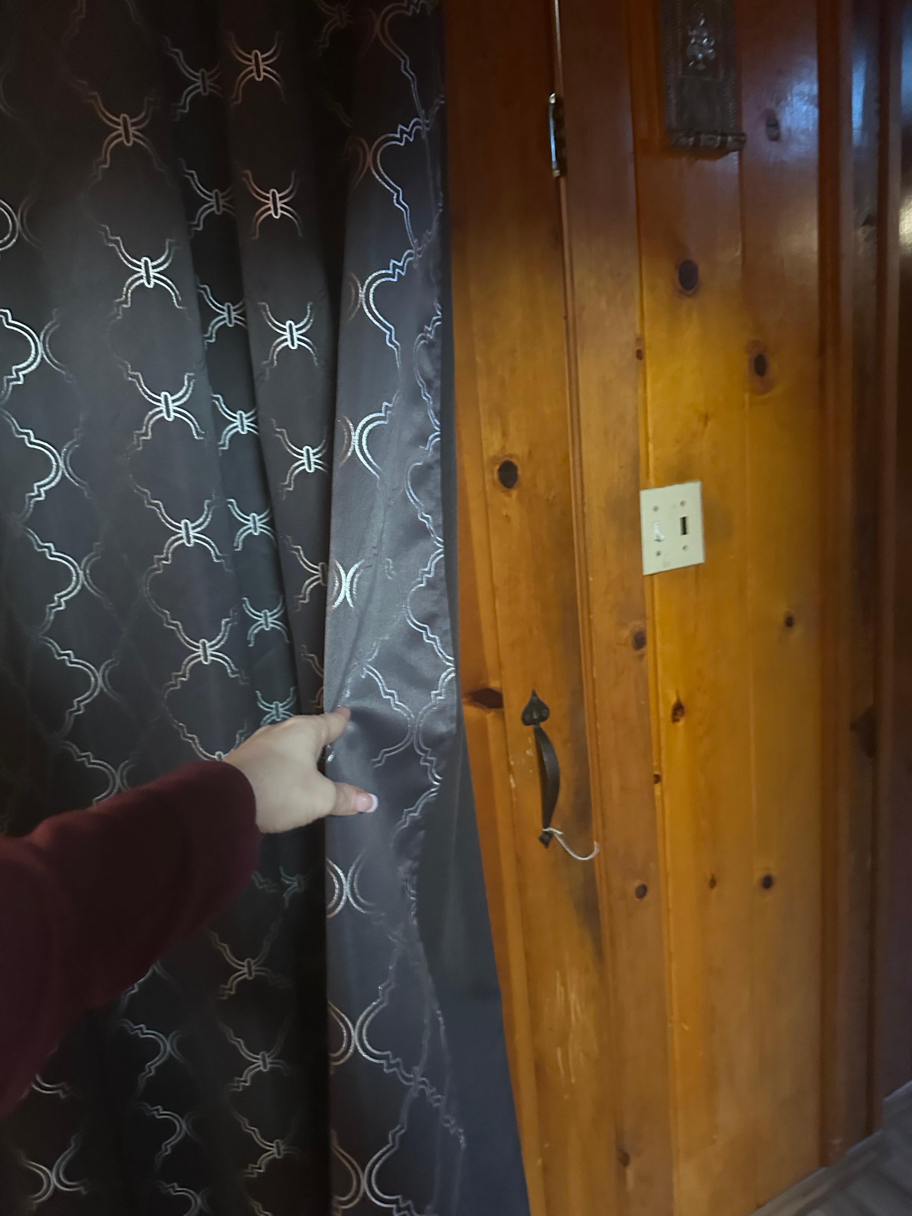 Inside the cabin, the door covered by a makeshift curtain 