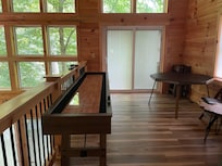 Shuffle board table and card table in corner
Doors lead to 3rd story balcony w table and 2 chairs