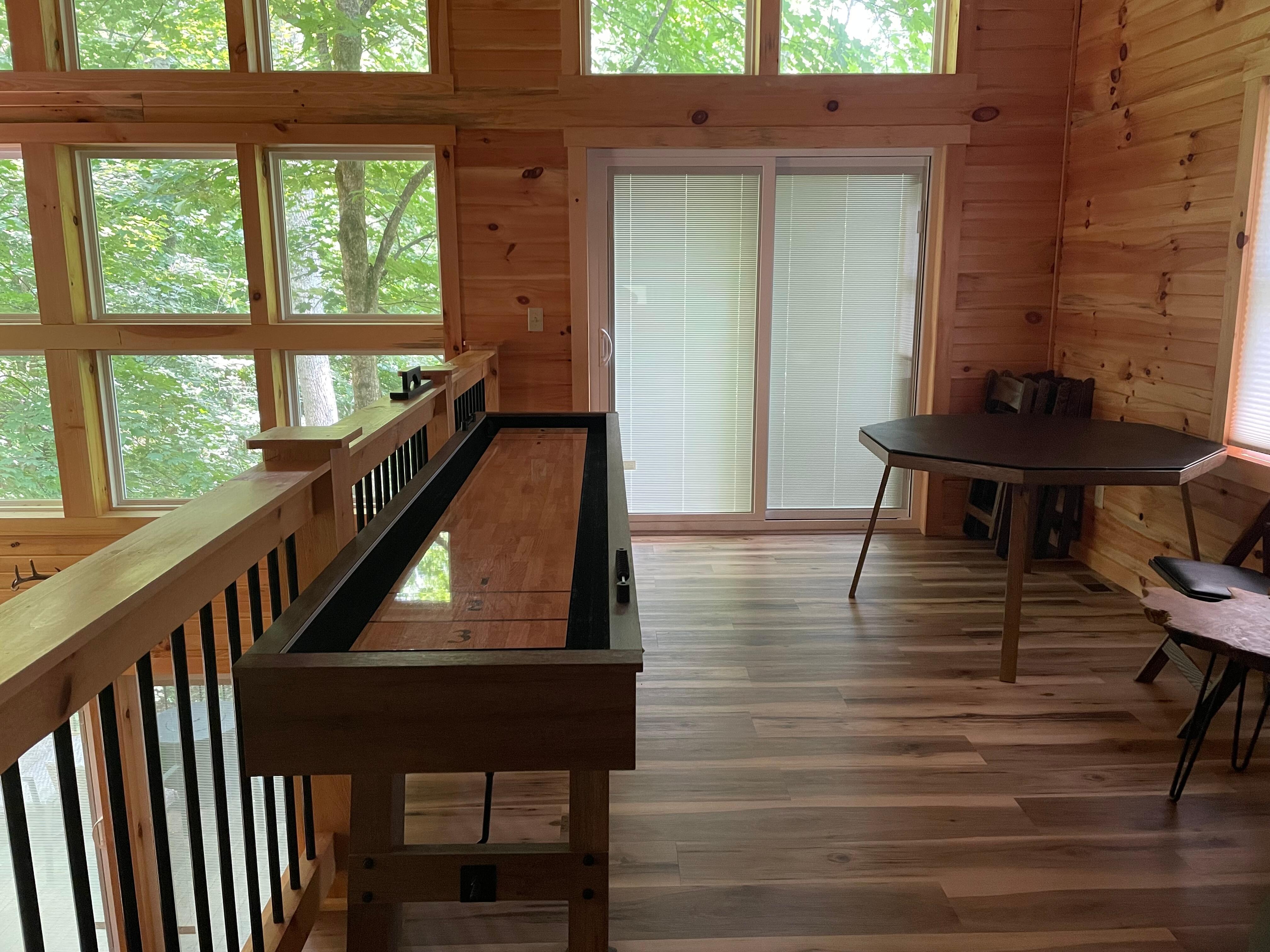 Shuffle board table and card table in corner
Doors lead to 3rd story balcony w table and 2 chairs