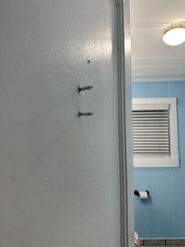Nails sticking out the bathroom door