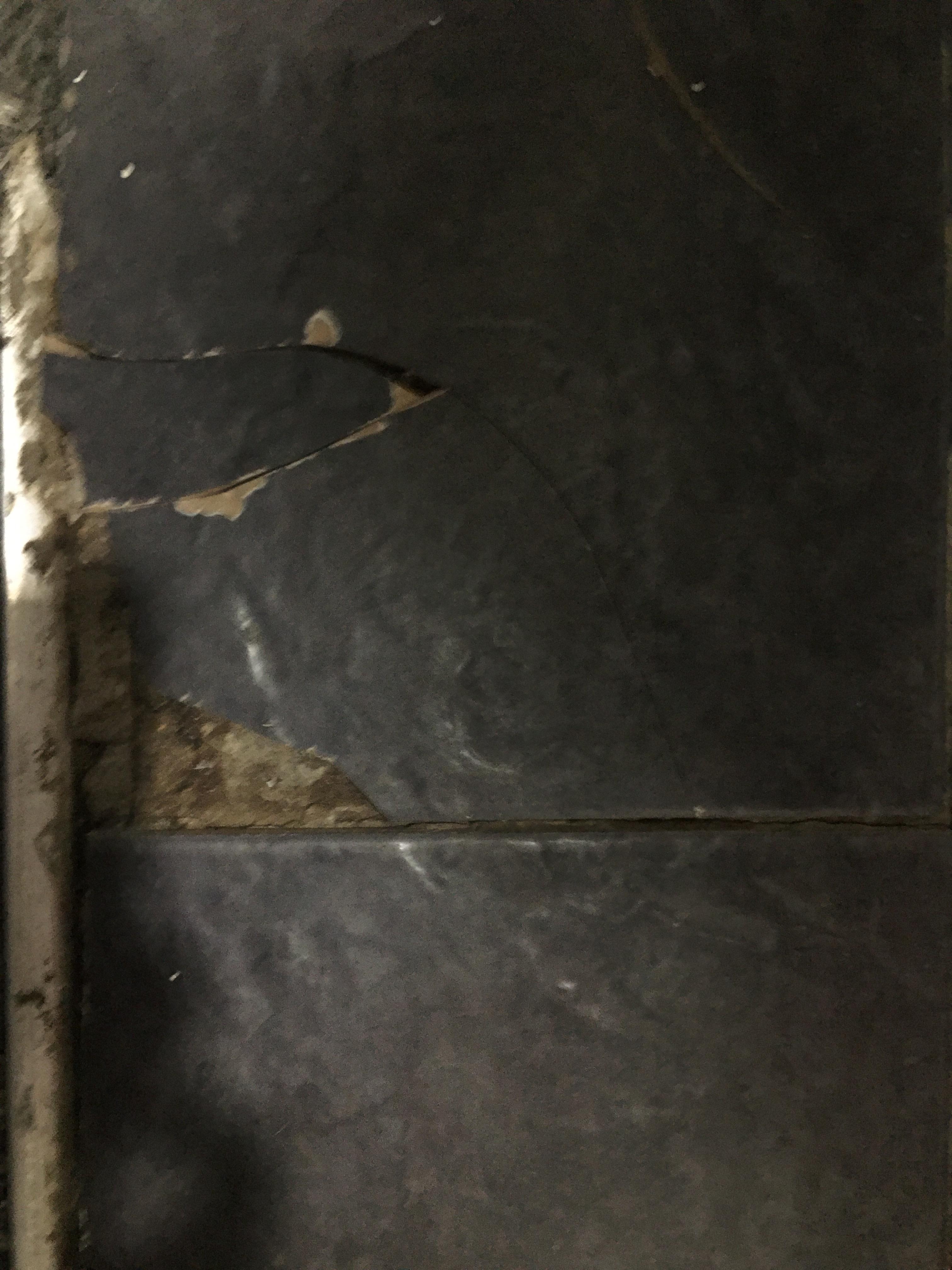 Cracked tiles in bathroom that could cut feet.