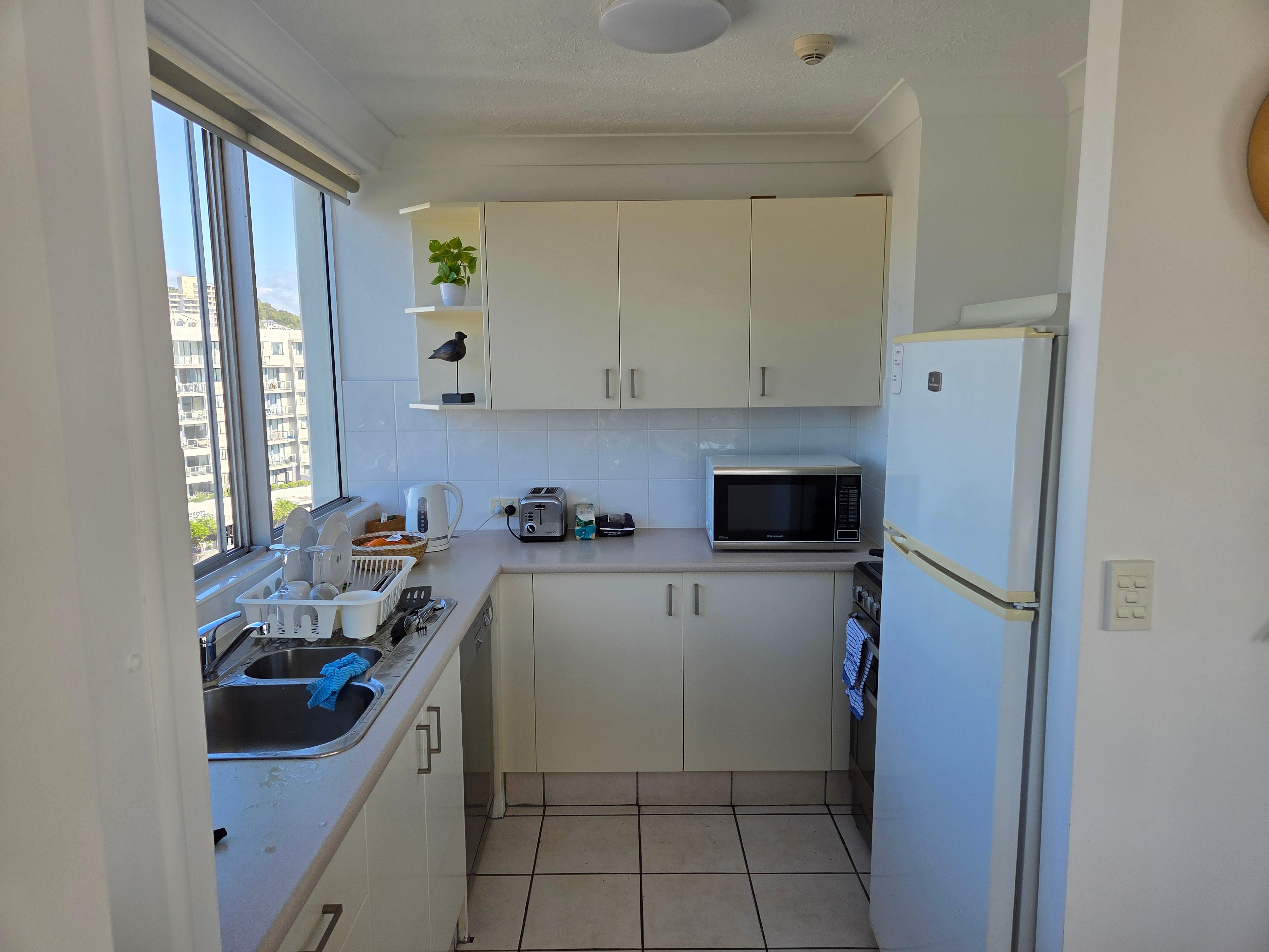 Small kitchen tucked away.  Very cramped compared to photos