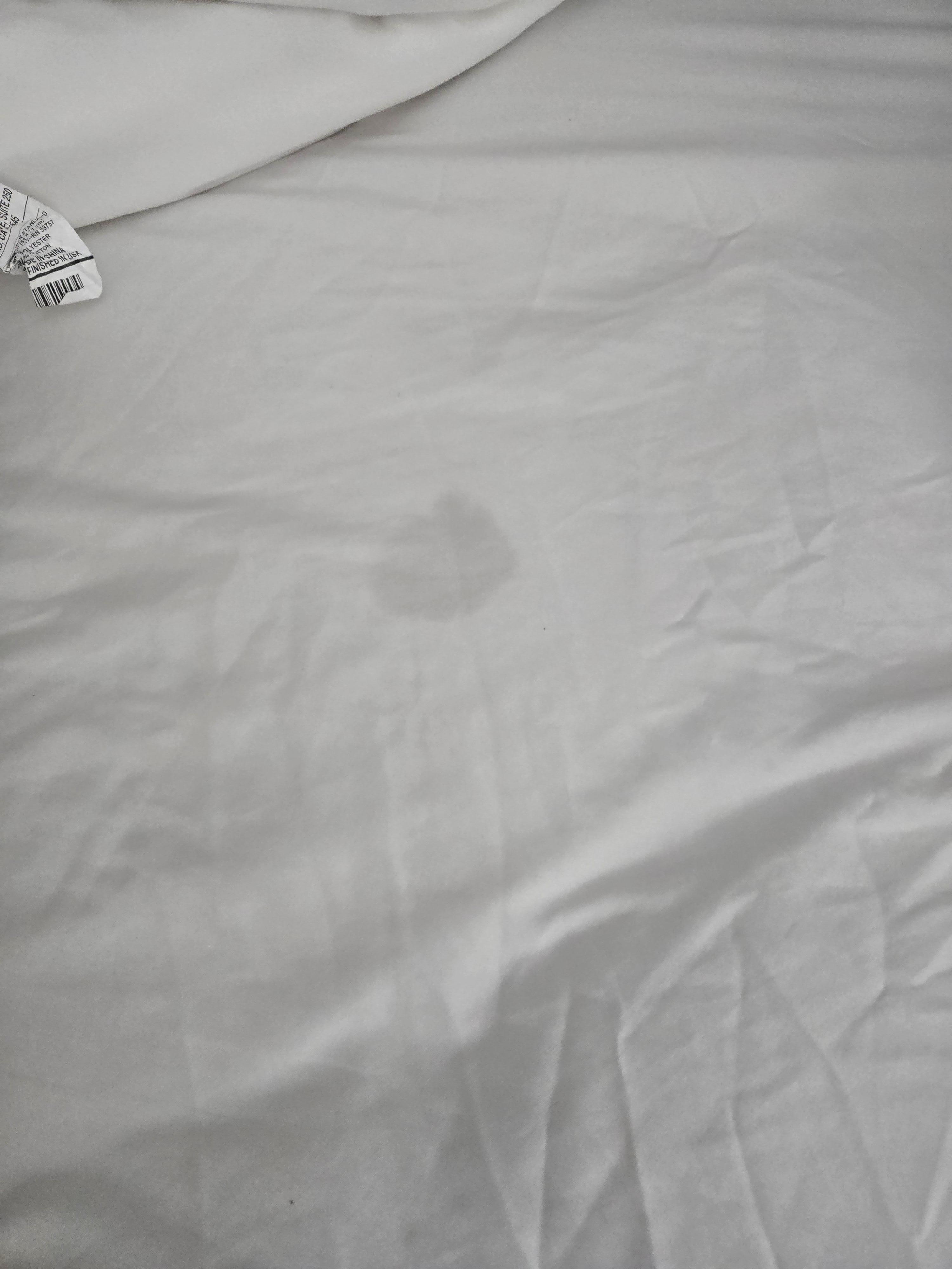 Spot on mattress pad visible through the sheet.  