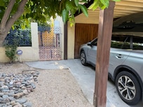 Covered parking, which is nice. Cute side gate.