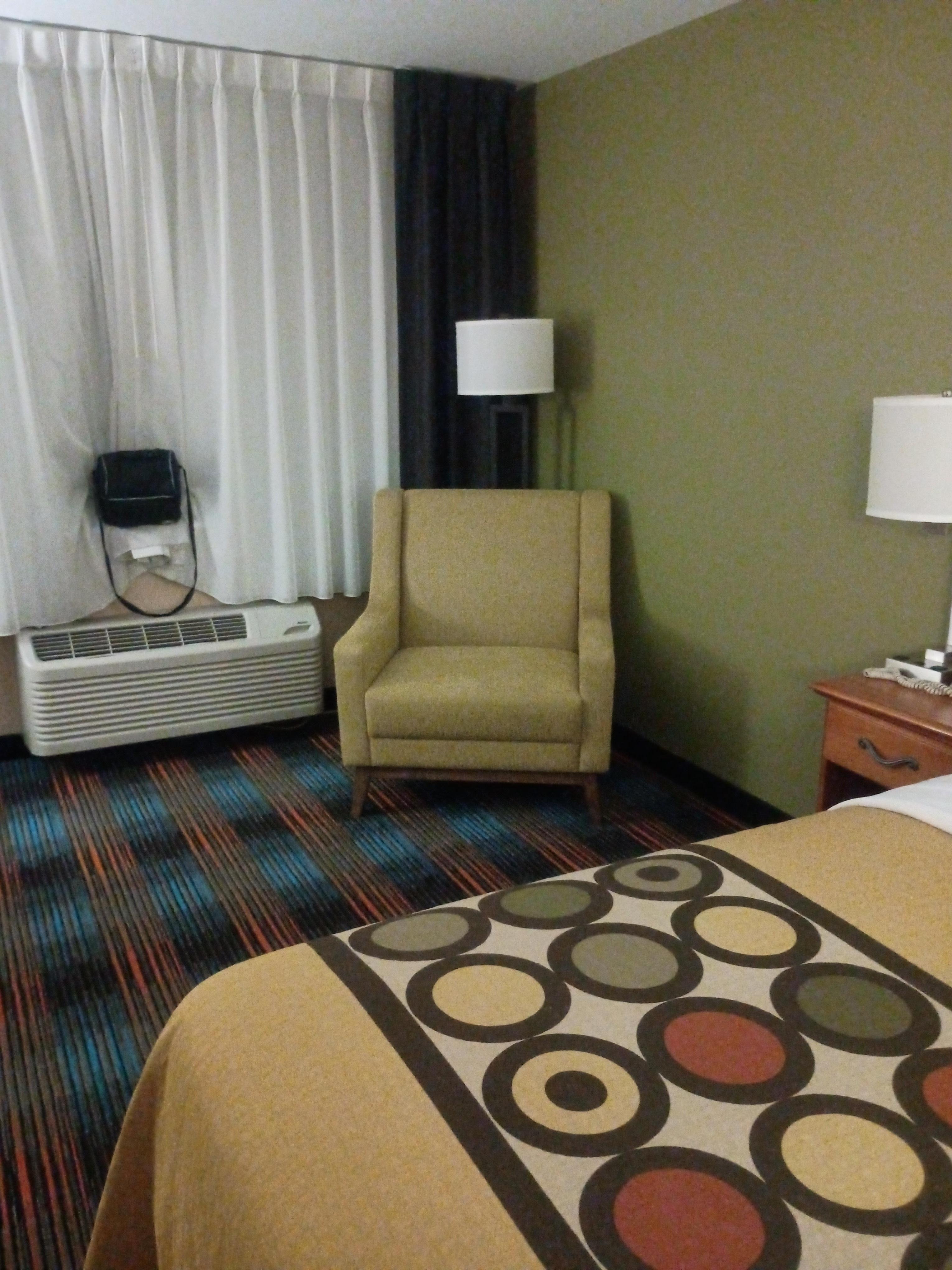 Chairs have been changed since the pictures were taken on the site. So no ottomans, but the chair was still very comfy and roomy.