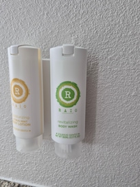 Body soap near sink, outside shower area