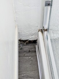 Leaking shower has damaged the wall and floor.