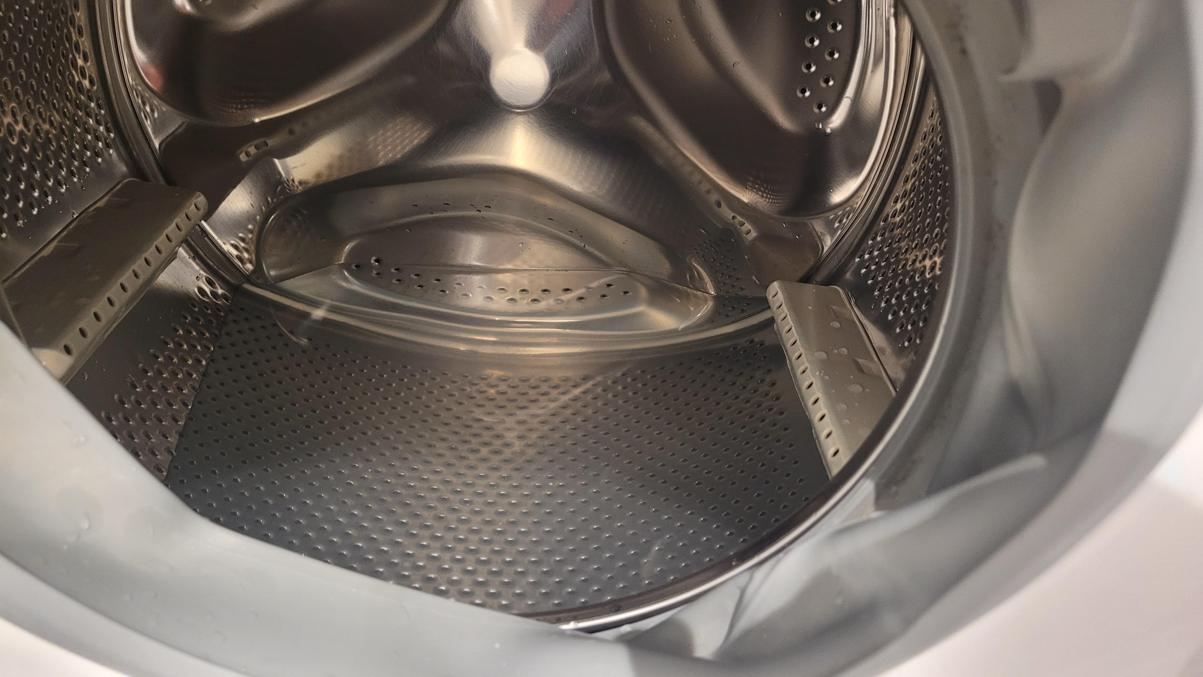 Broken laundry machine with standing water in it