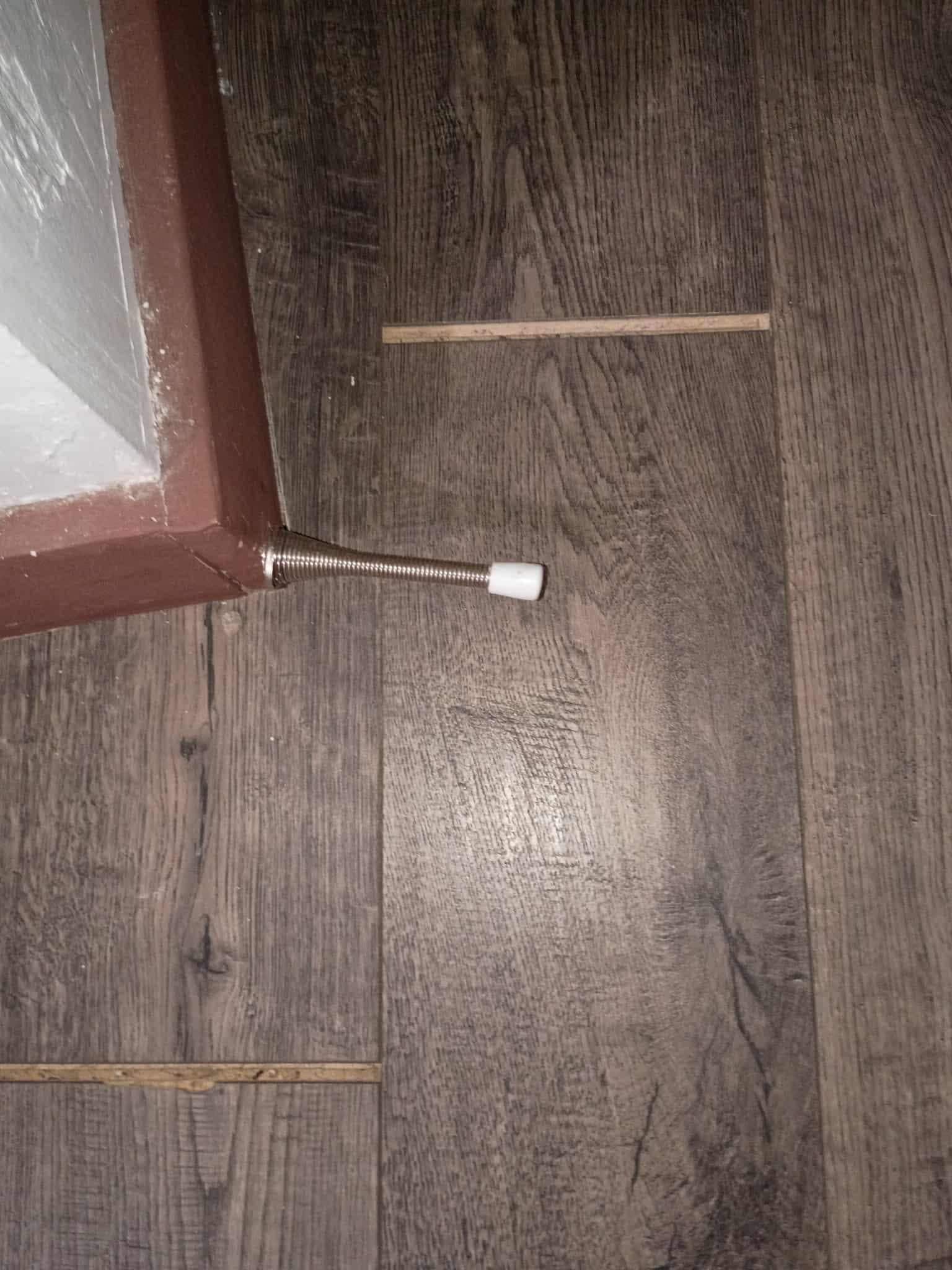 Cracks in flooring throughout the unit.