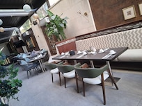 The indoor/outdoor dining room is absolutely delightful