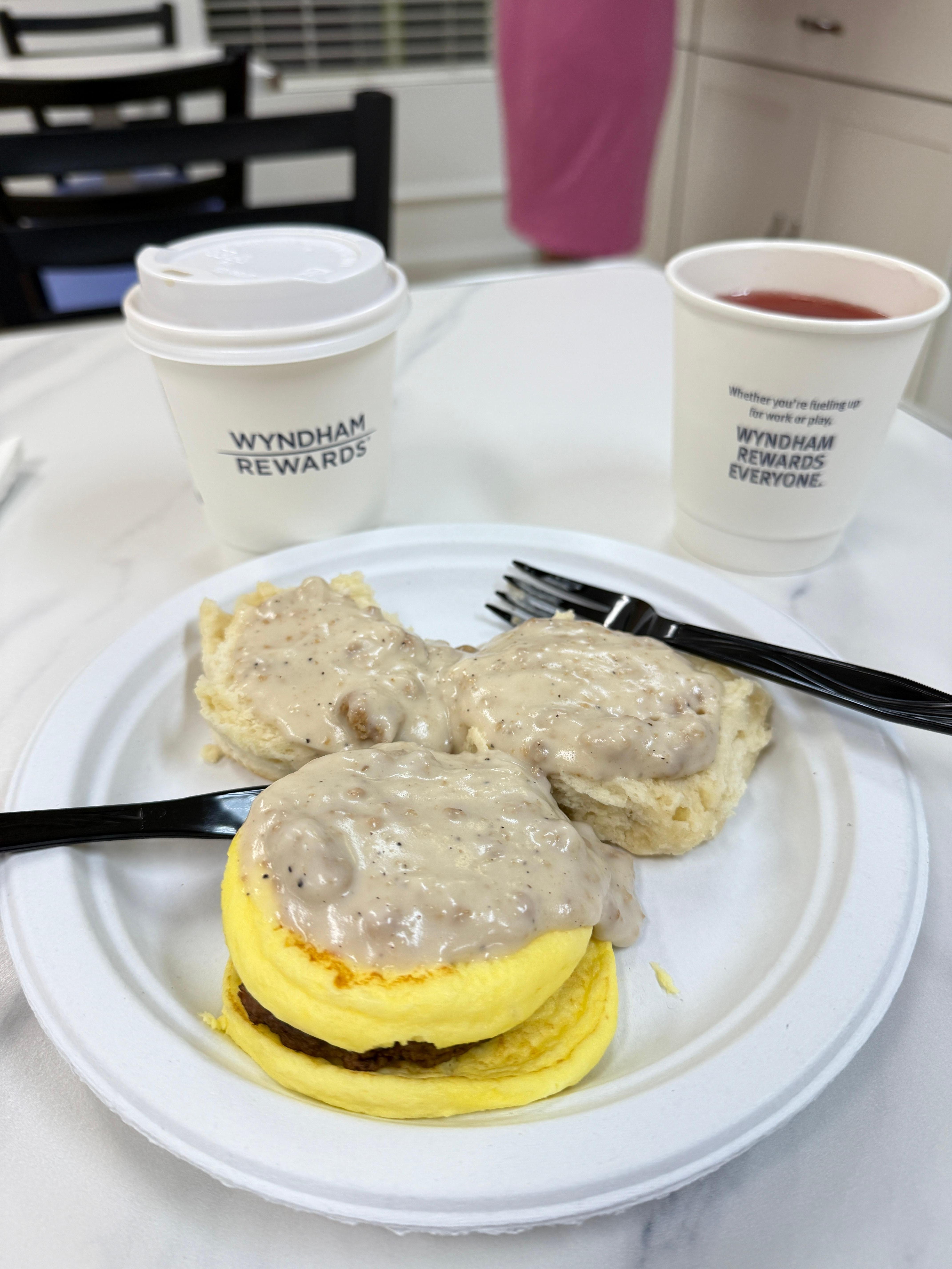 Sausage gravy, biscuits, sausage, coffee and juice 