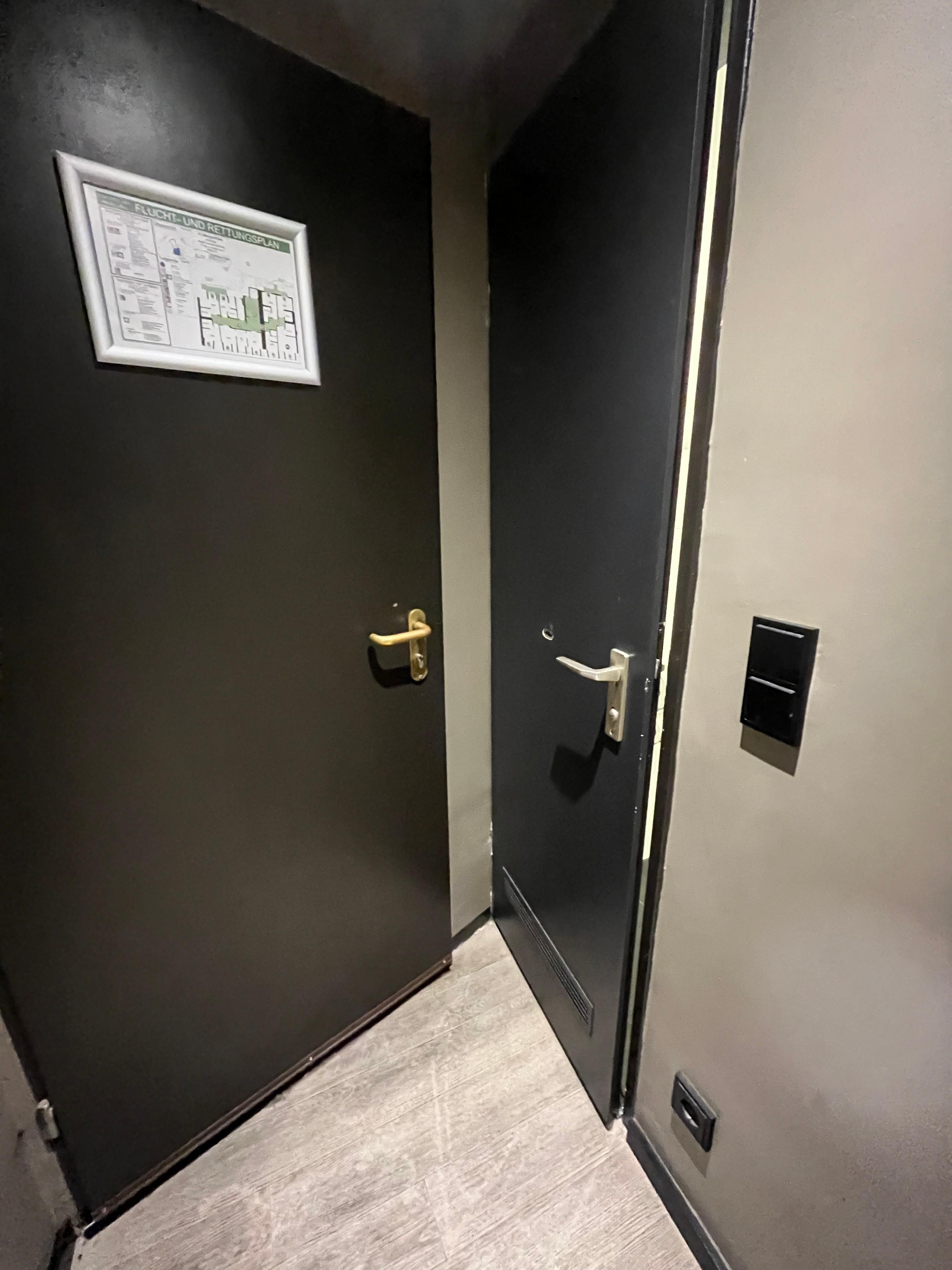 Entrance door on left, bathroom door on right