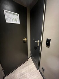 Entrance door on left, bathroom door on right