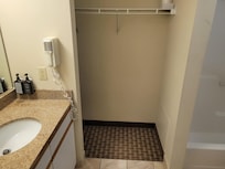 Bathroom, large closet space with ironing board.