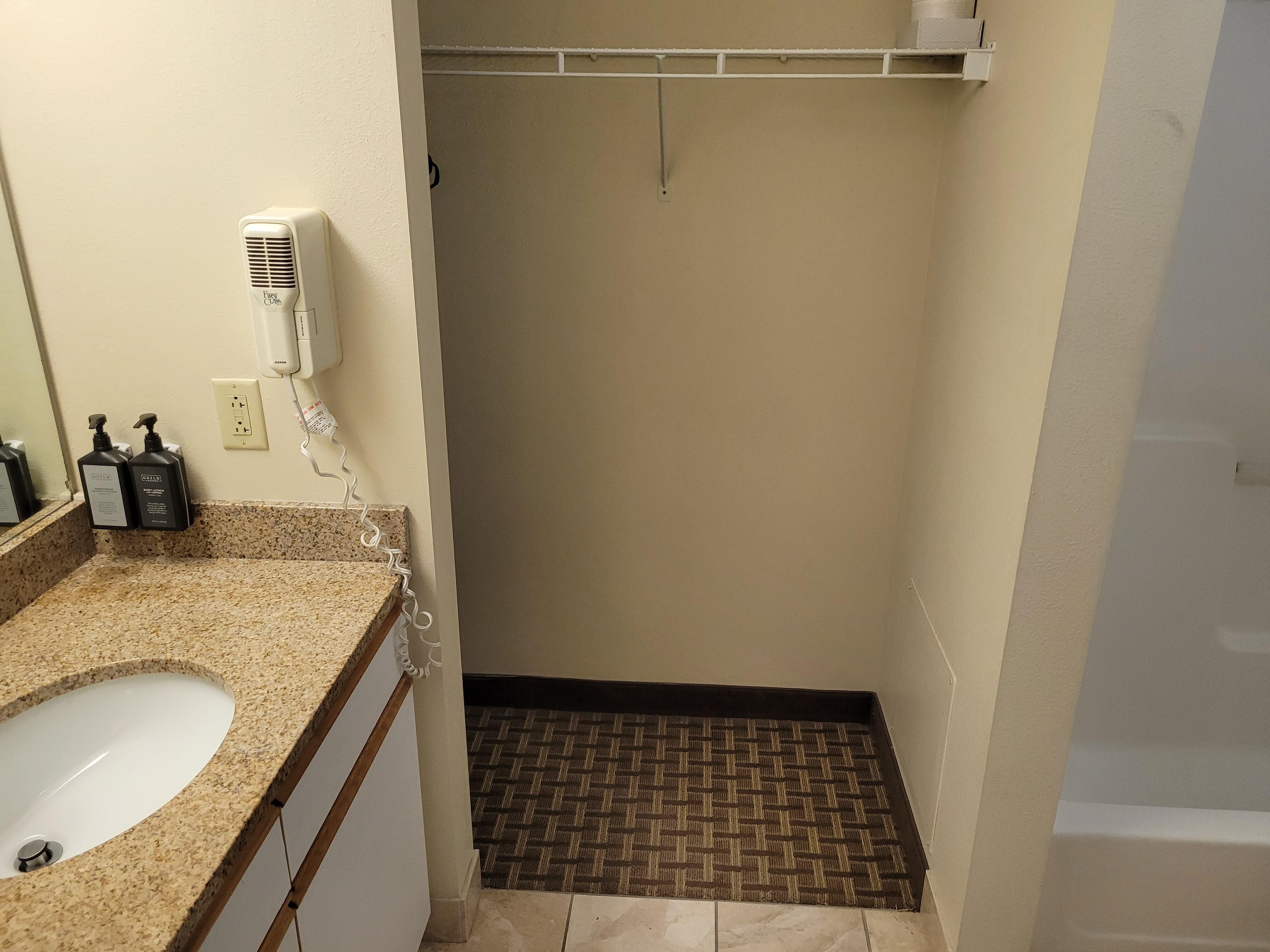 Bathroom, large closet space with ironing board.