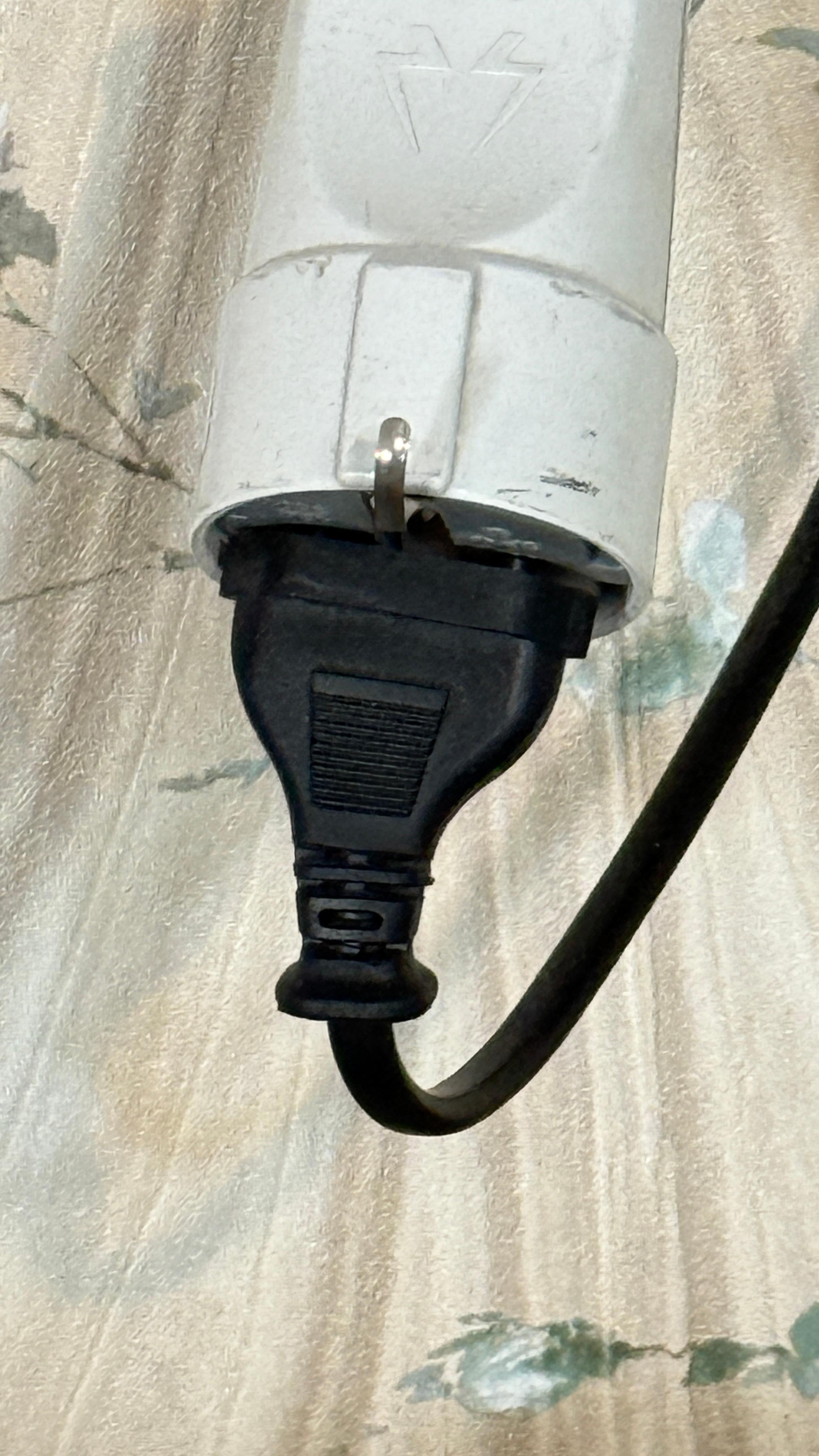 plug hanging on top of the sofa