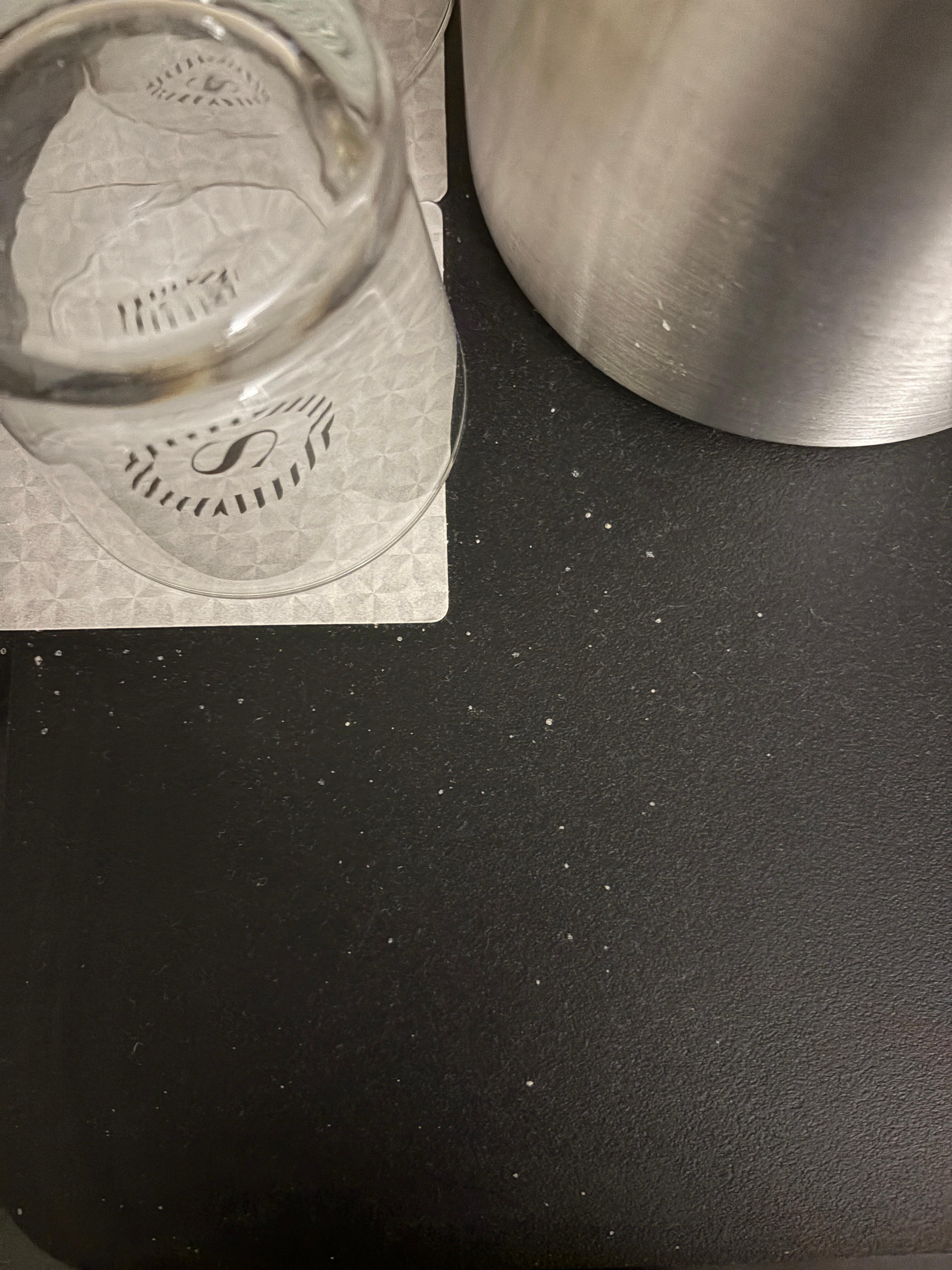 Small portion of random white splatter on serving tray with glassware. I scrubbed the counters myself to remove it. 