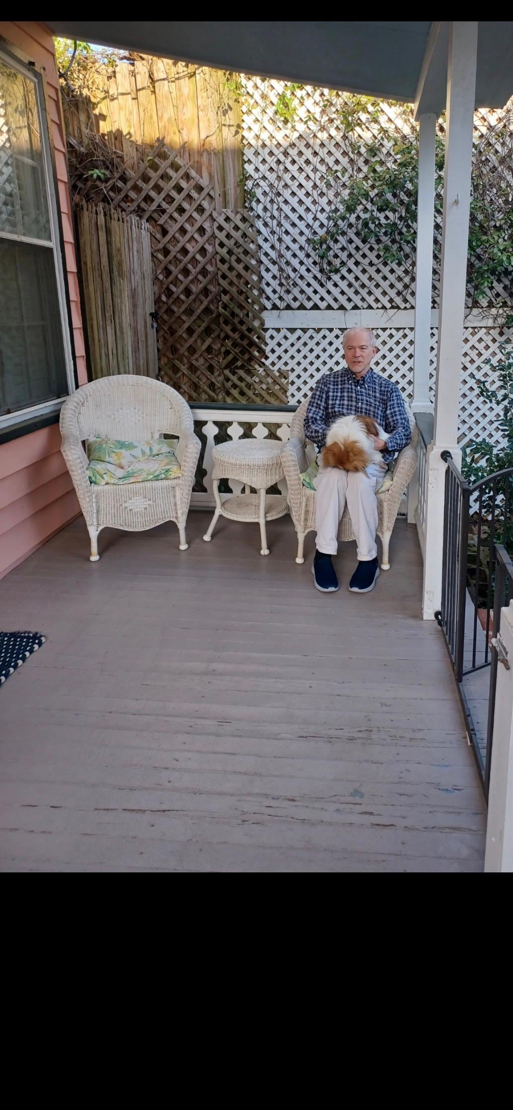 Our host and his pet, Precious, on one of our porches. 