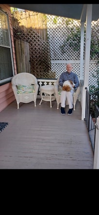 Our host and his pet, Precious, on one of our porches.