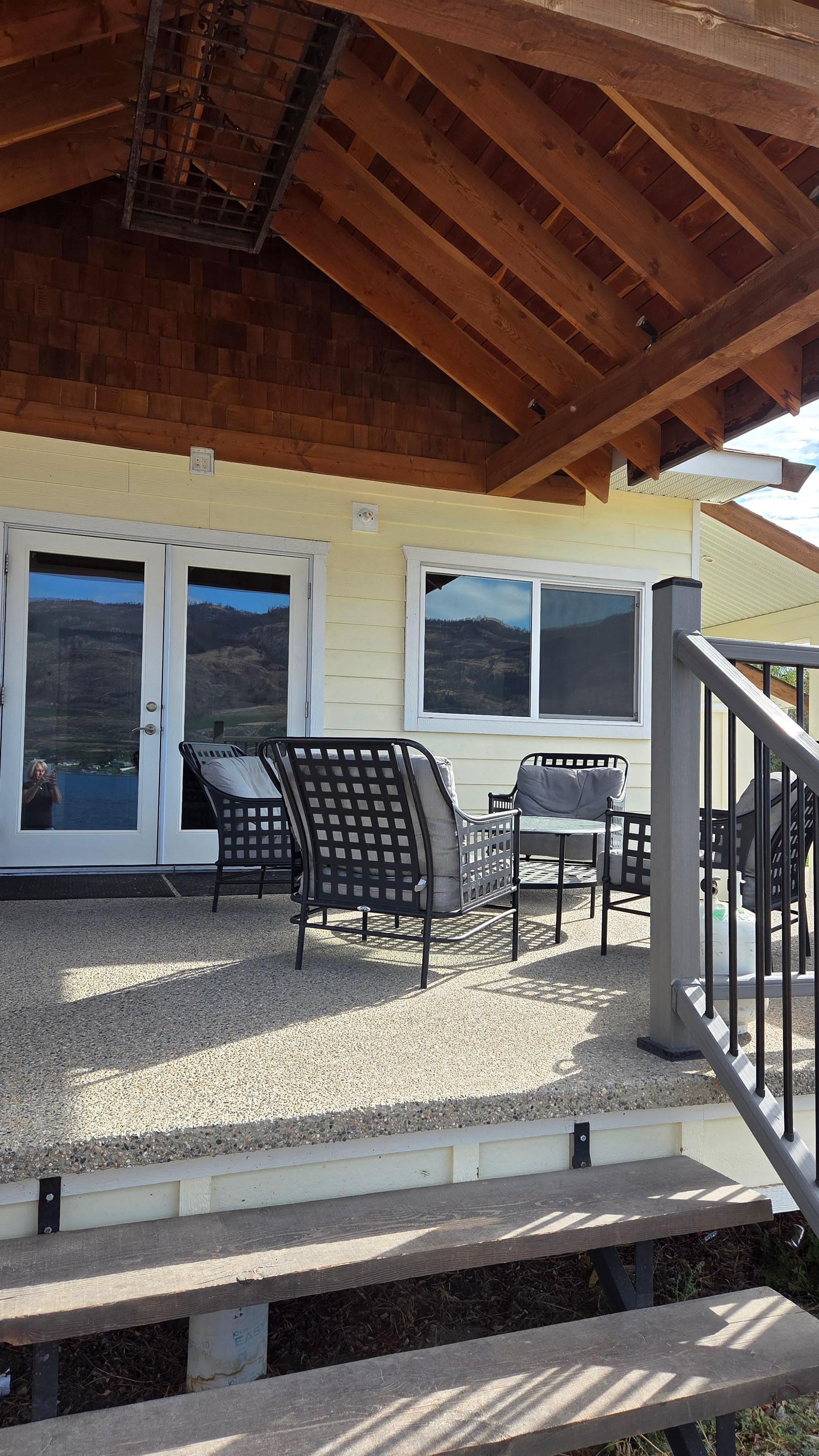 The patio on the west side facing beach, seating for 4, BBQ to the side
