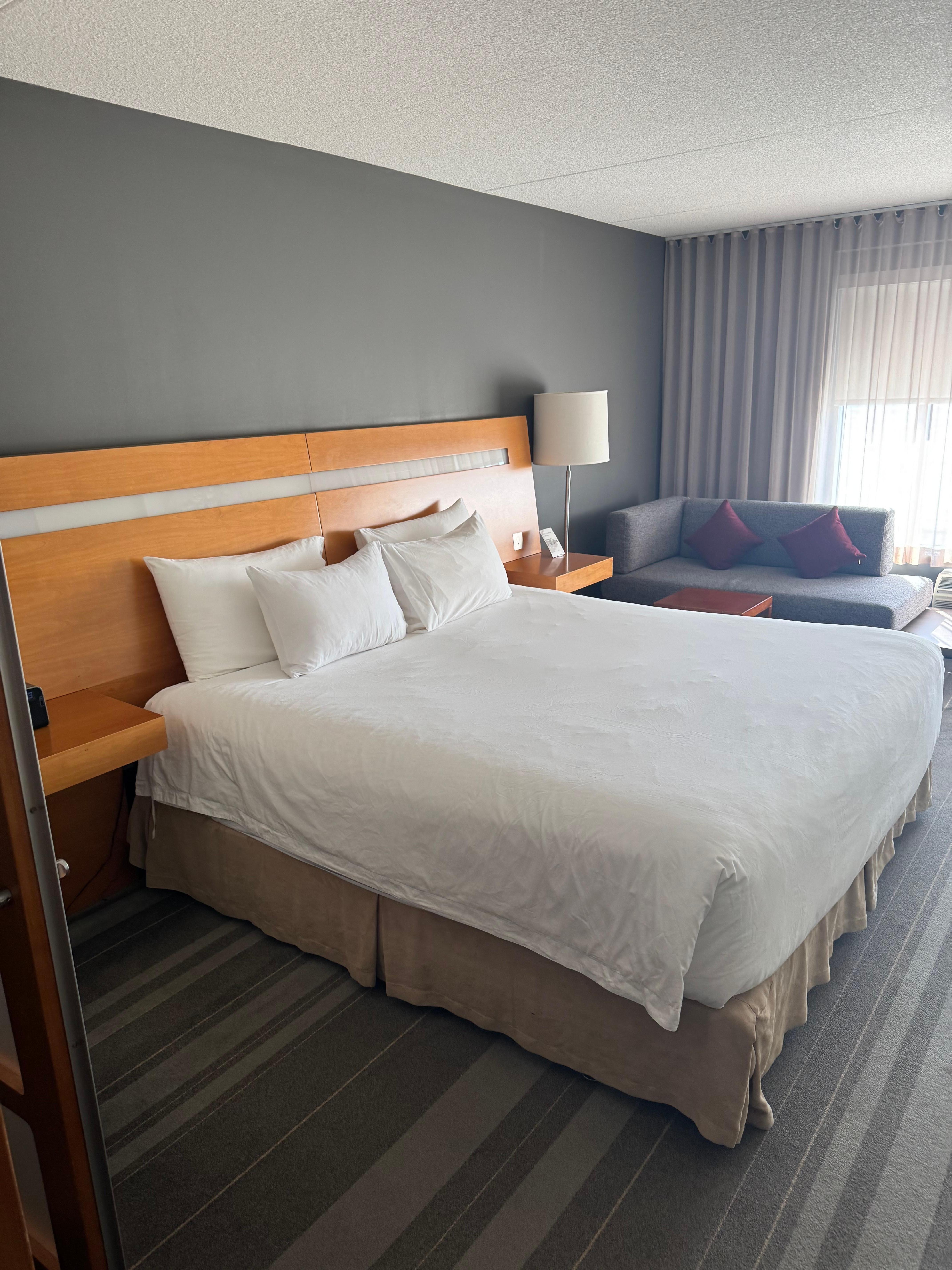 Standard king size bed on the third floor viewing the restaurant patio in front of hotel