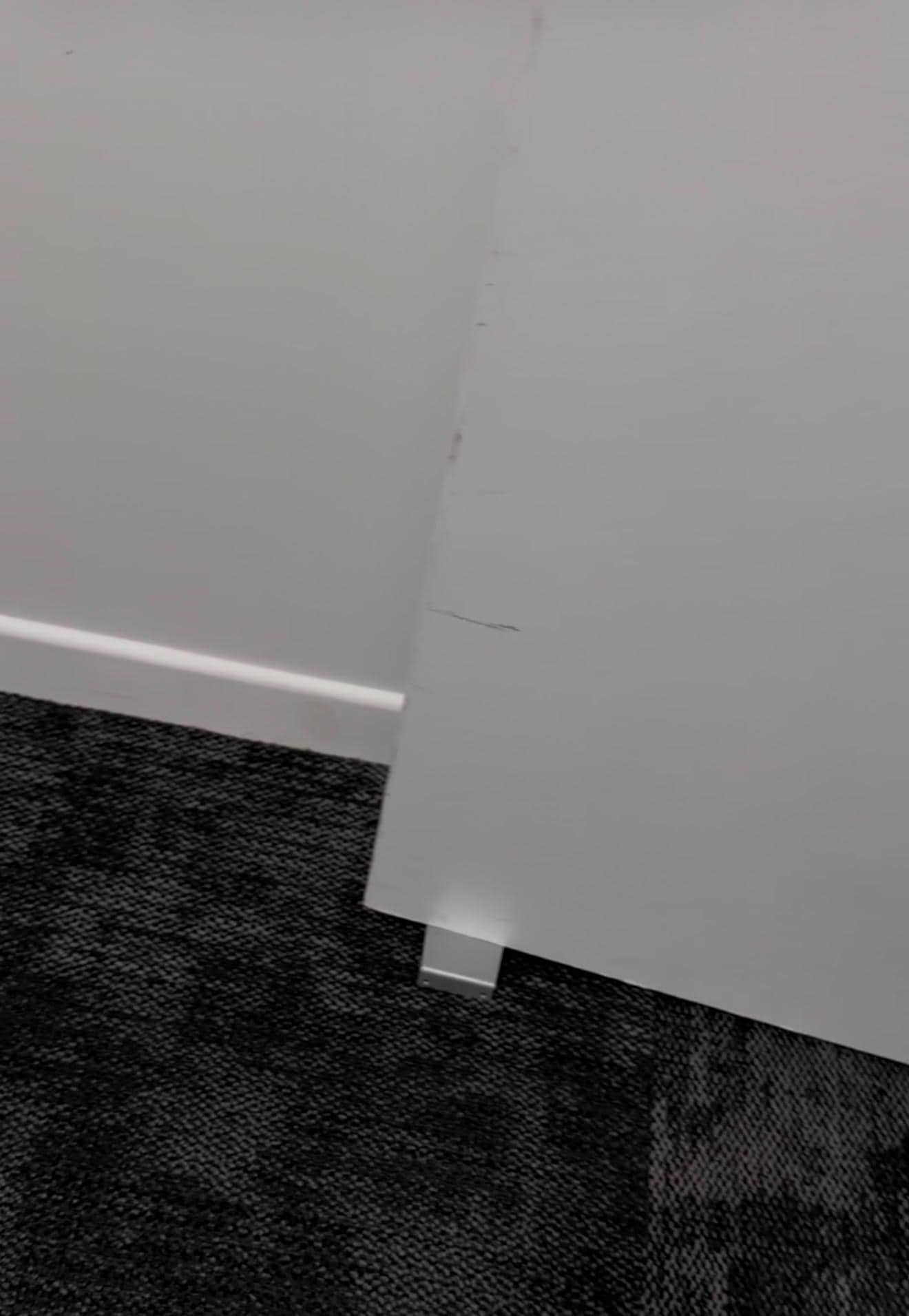 Fire door wedged open on ground floor near bottom of stairs and lift