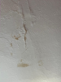 Damp patch above the bed