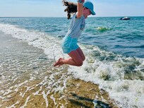 Jumping the waves on the shore at our beach.