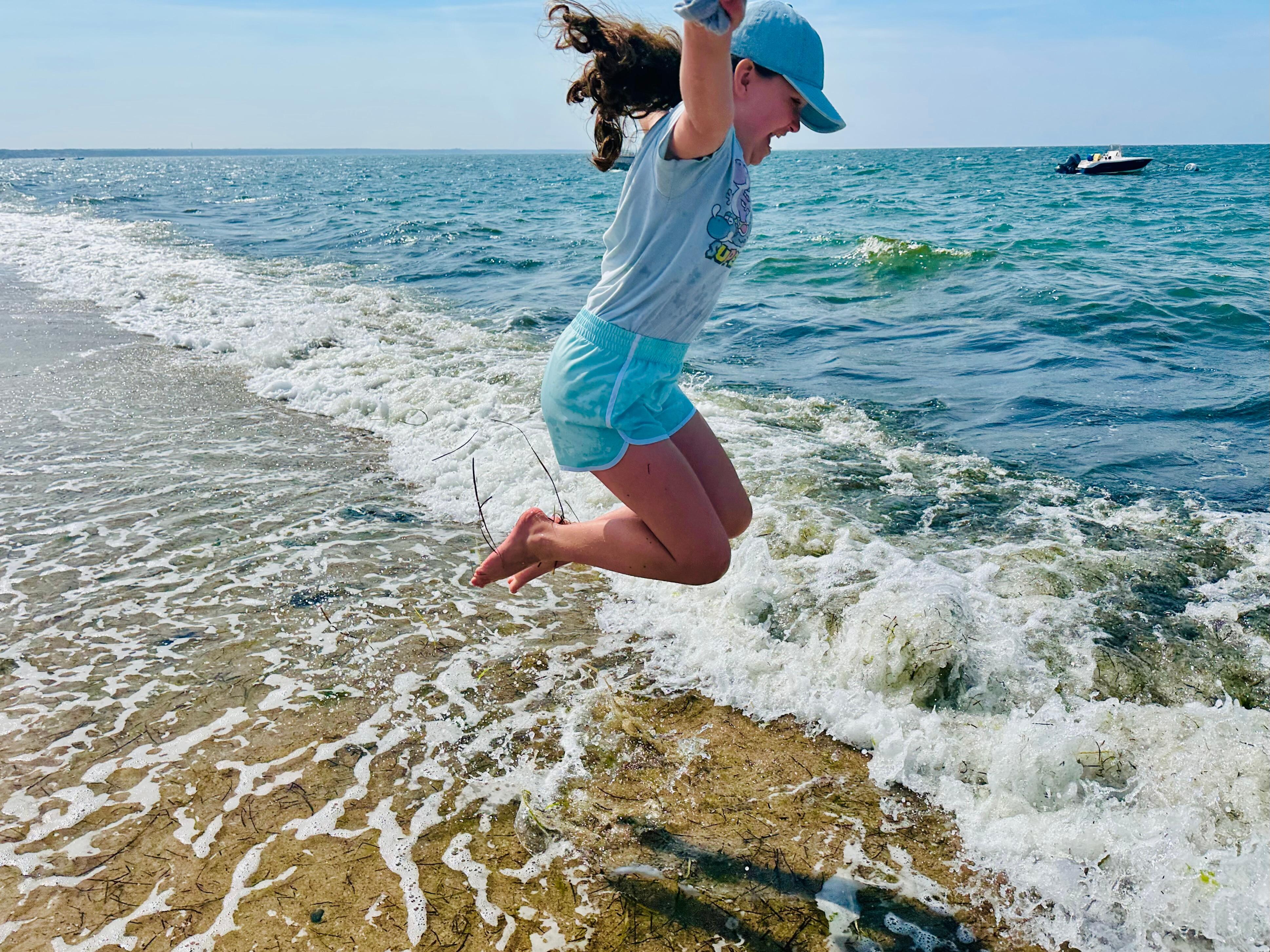 Jumping the waves on the shore at our beach.