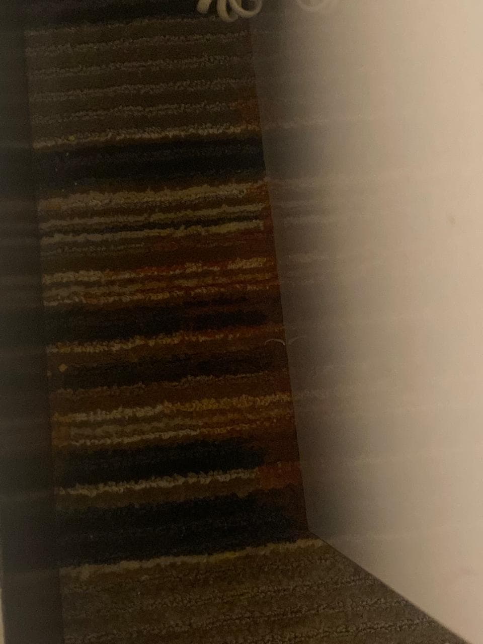 wet red stain on side of night stand