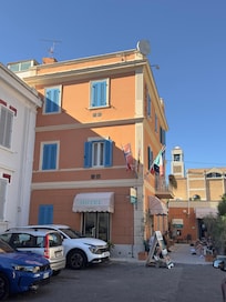 Hotel with partial view of parking lot.