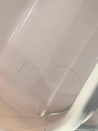 Hair inside shelf of fridge
